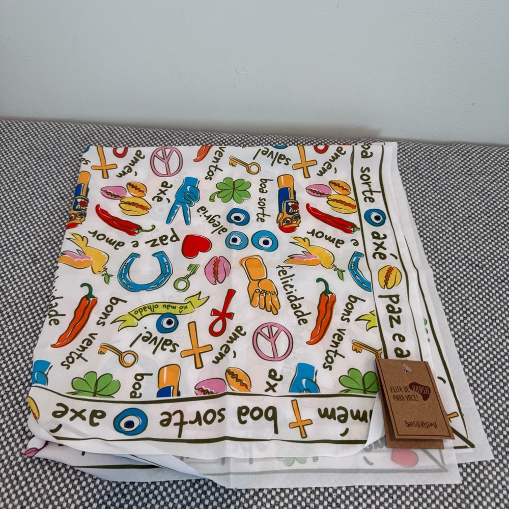 Scarf or neckerchief with good luck symbols and phrases in Portuguese.